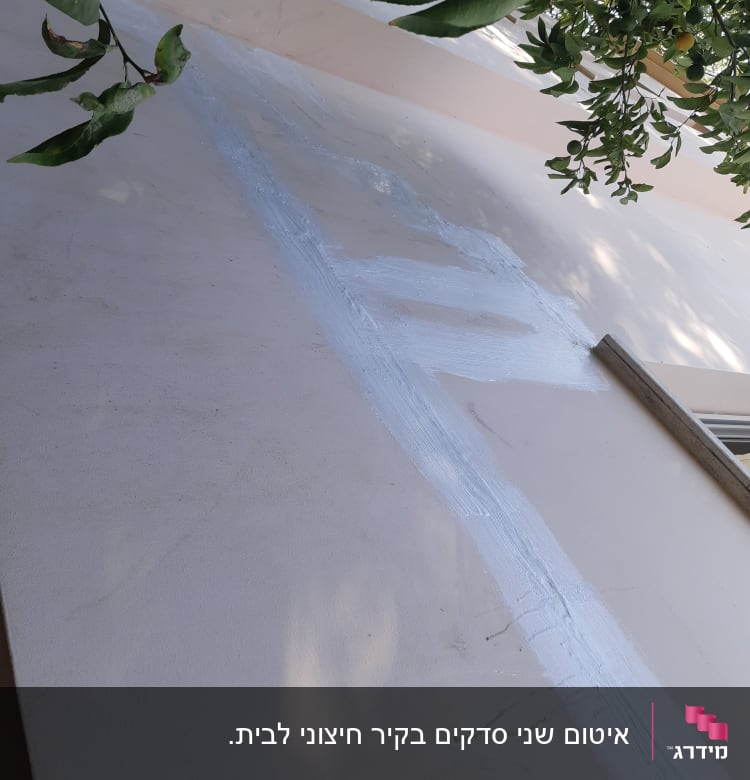 קיר עם איטום לבן לאורך סדק